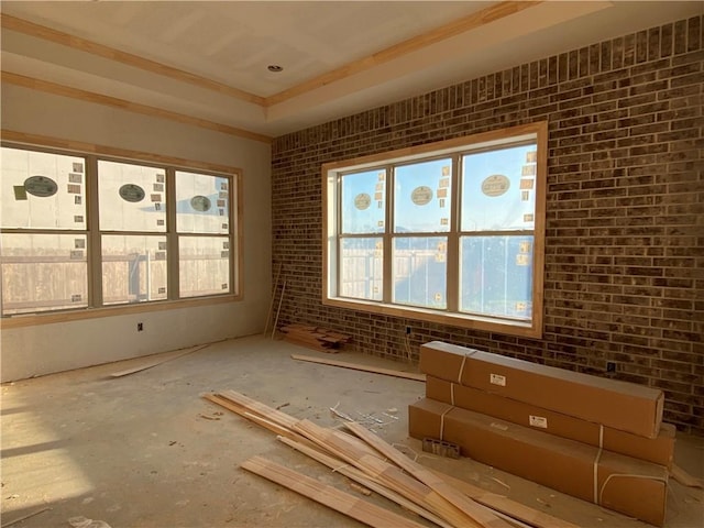 misc room with brick wall and ornamental molding