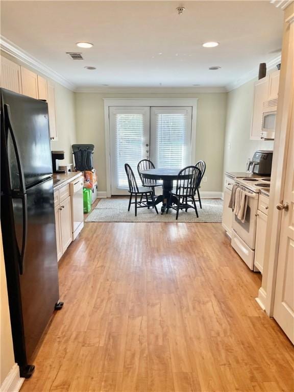 kitchen featuring crown molding, white cabinets, white appliances, and light hardwood / wood-style flooring