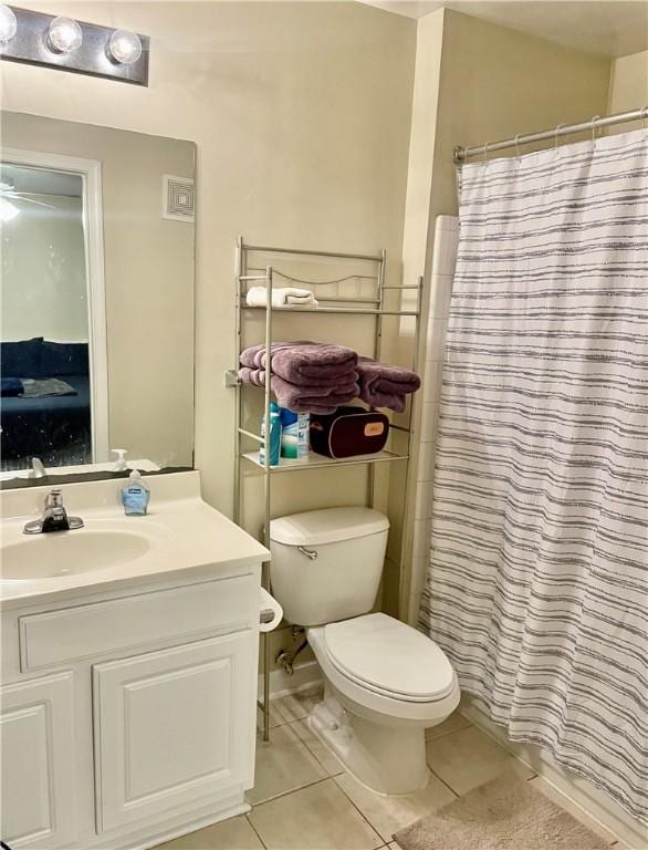 bathroom featuring walk in shower, tile patterned floors, and vanity