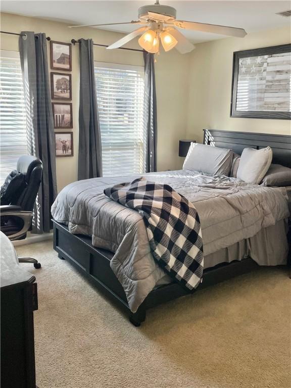 bedroom featuring ceiling fan and carpet floors