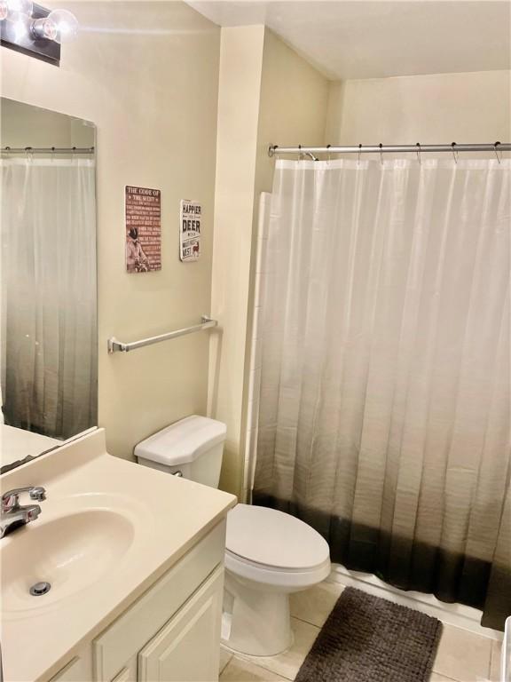 bathroom with vanity, tile patterned floors, and toilet