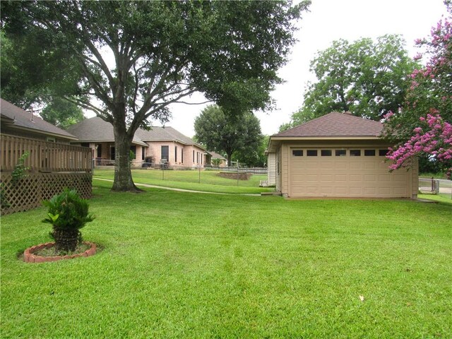 2400 Brookbend Dr, Brenham, TX 77833 - view of yard with a detached garage, an outbuilding, and a wooden deck