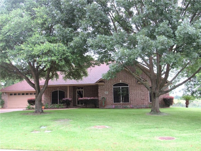 2400 Brookbend Dr, Brenham, TX 77833 - view of front of house featuring a garage, a front yard, and roof with shingles