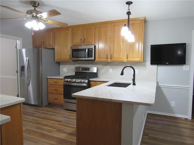 2400 Brookbend Dr, Brenham, TX 77833 - kitchen featuring appliances with stainless steel finishes, a peninsula, dark wood-style flooring, and decorative light fixtures