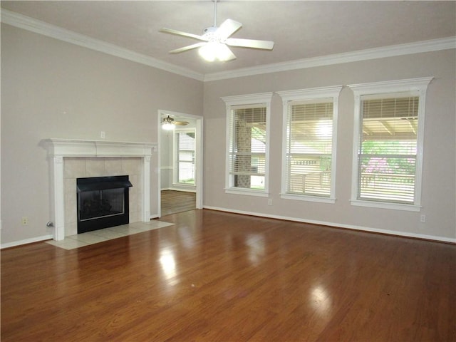 2400 Brookbend Dr, Brenham, TX 77833 - unfurnished living room with wood finished floors, healthy amount of natural light, ceiling fan, a tile fireplace, and crown molding