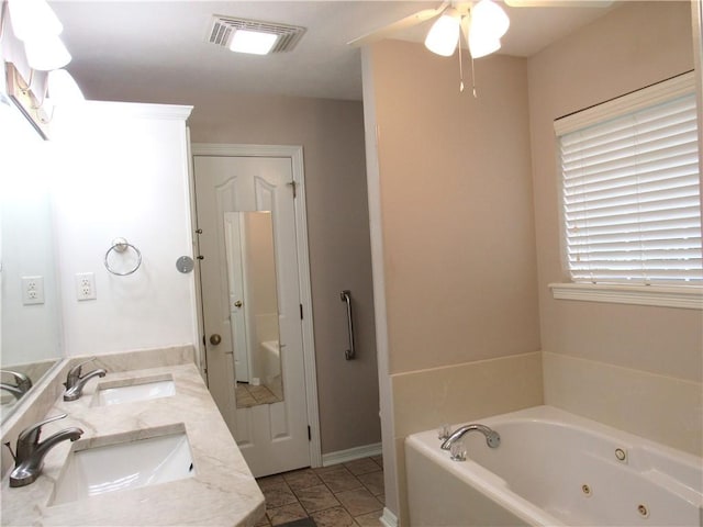 2400 Brookbend Dr, Brenham, TX 77833 - bathroom featuring double vanity, a jetted tub, and ceiling fan