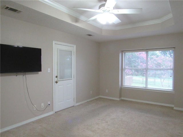2400 Brookbend Dr, Brenham, TX 77833 - carpeted empty room featuring ornamental molding, a raised ceiling, and a ceiling fan