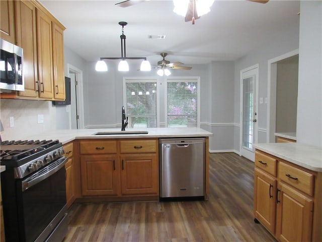 2400 Brookbend Dr, Brenham, TX 77833 - kitchen featuring stainless steel appliances, ceiling fan, a peninsula, dark wood-type flooring, and light countertops