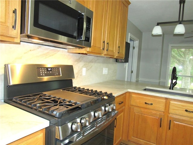 2400 Brookbend Dr, Brenham, TX 77833 - kitchen featuring stainless steel appliances, decorative backsplash, light countertops, and brown cabinets