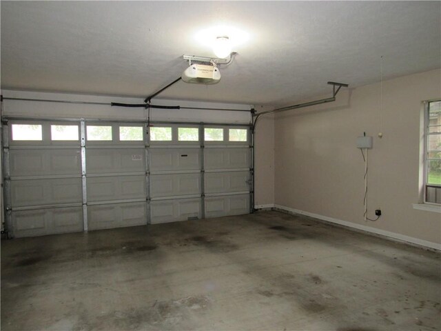 2400 Brookbend Dr, Brenham, TX 77833 - garage featuring a garage door opener and baseboards