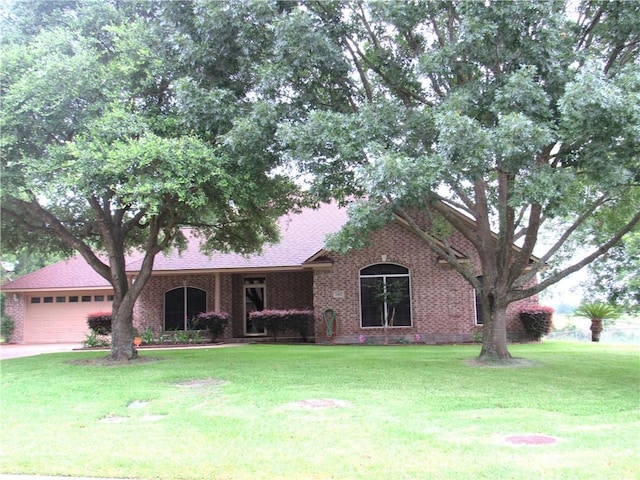 2400 Brookbend Dr, Brenham, TX 77833 - view of front of property featuring a garage, a front lawn, and roof with shingles
