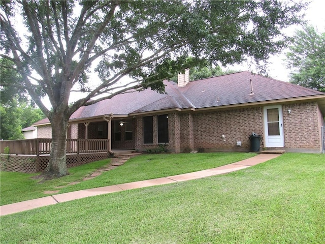 2400 Brookbend Dr, Brenham, TX 77833 - rear view of property with a chimney, a yard, a shingled roof, and a deck
