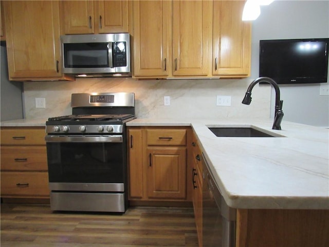 2400 Brookbend Dr, Brenham, TX 77833 - kitchen with appliances with stainless steel finishes, a peninsula, dark wood finished floors, and backsplash