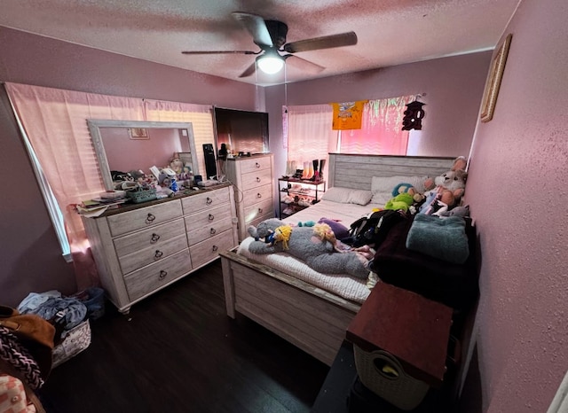 bedroom featuring a textured ceiling, ceiling fan, and dark wood-type flooring