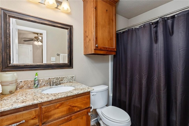 bathroom with ceiling fan, a shower with shower curtain, vanity, a textured ceiling, and toilet