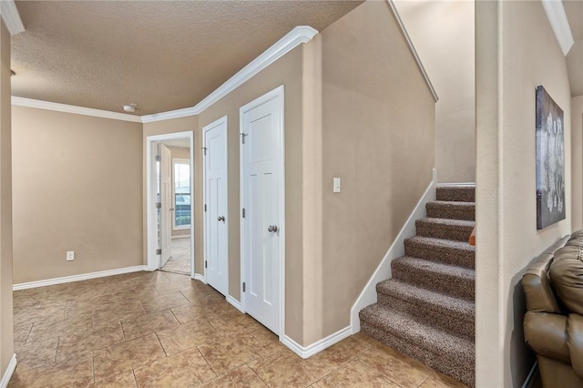 stairway featuring crown molding and a textured ceiling