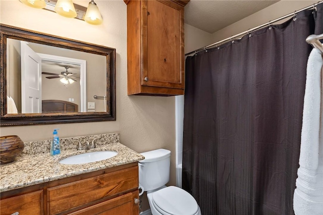 bathroom featuring vanity, ceiling fan, and toilet