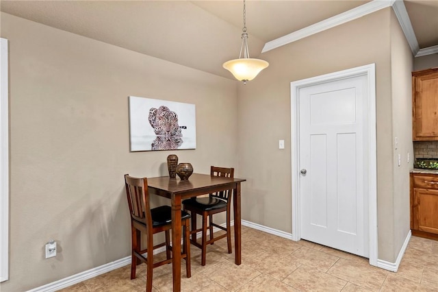 dining space with crown molding and light tile patterned flooring