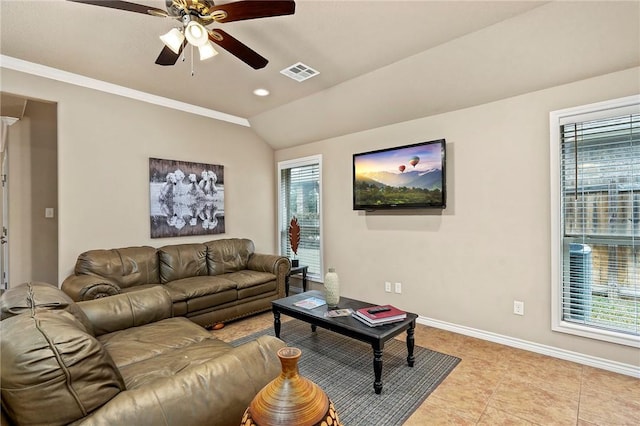 living room with lofted ceiling, light tile patterned floors, a wealth of natural light, and ceiling fan