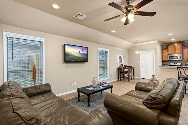 living room featuring a textured ceiling, ceiling fan, light colored carpet, and vaulted ceiling