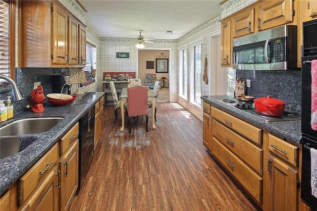 2801 Celinda Cir, College Station, TX 77845 - kitchen featuring black appliances, wallpapered walls, dark wood-type flooring, backsplash, and ceiling fan