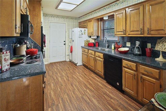 2801 Celinda Cir, College Station, TX 77845 - kitchen featuring a sink, dishwasher, brown cabinetry, and backsplash