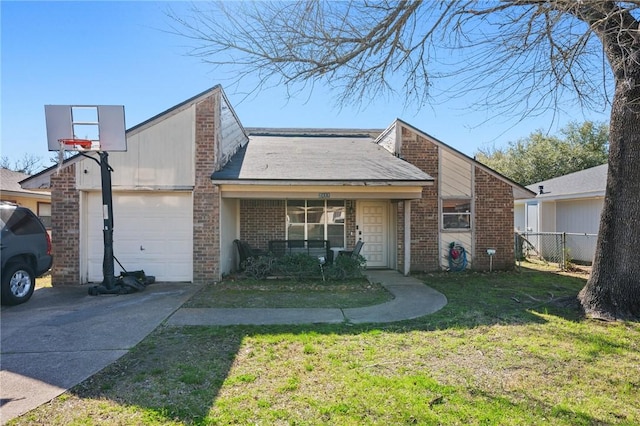 view of front of property featuring brick siding, a front yard, fence, a garage, and driveway