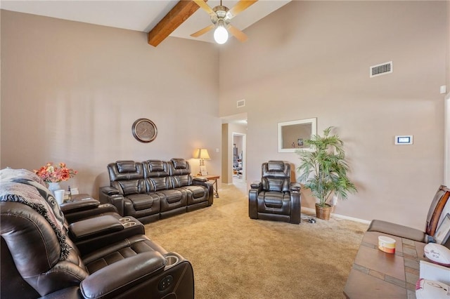 carpeted living area with baseboards, visible vents, a ceiling fan, beamed ceiling, and a high ceiling