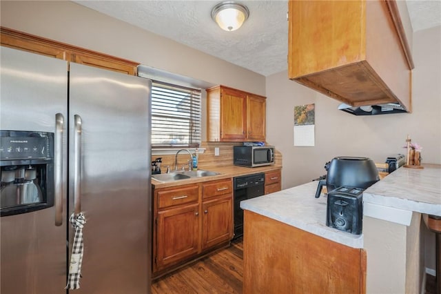 kitchen featuring light countertops, custom range hood, appliances with stainless steel finishes, dark wood-type flooring, and a sink