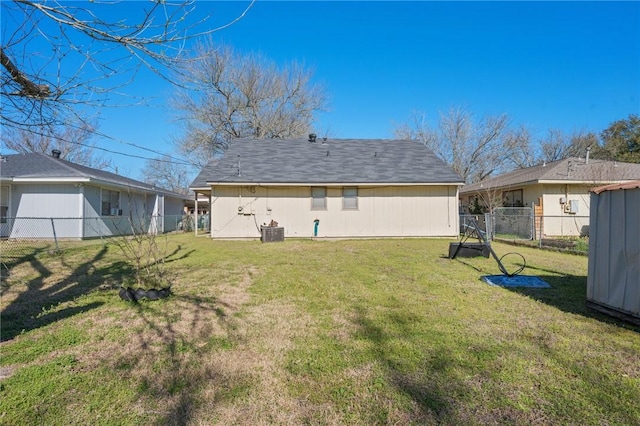 back of house with a yard, cooling unit, and fence