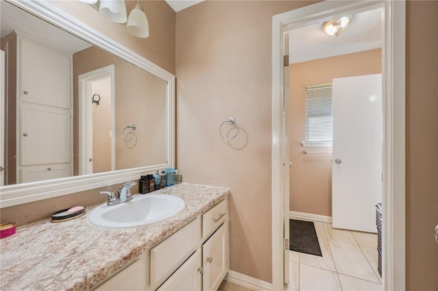 bathroom featuring tile patterned flooring, vanity, and baseboards