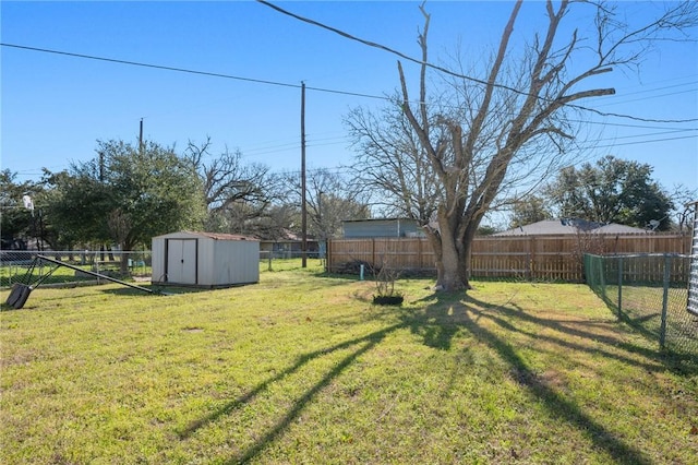 view of yard with an outbuilding, a fenced backyard, and a storage shed