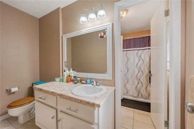 bathroom with tile patterned flooring, a shower with curtain, vanity, and toilet