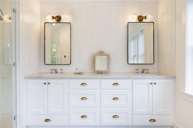 bathroom featuring a sink, decorative backsplash, and a stall shower