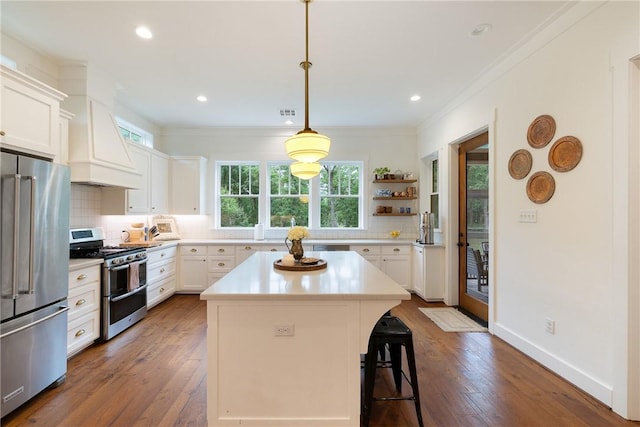 kitchen with custom range hood, ornamental molding, plenty of natural light, and stainless steel appliances