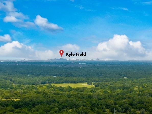 birds eye view of property featuring a view of trees