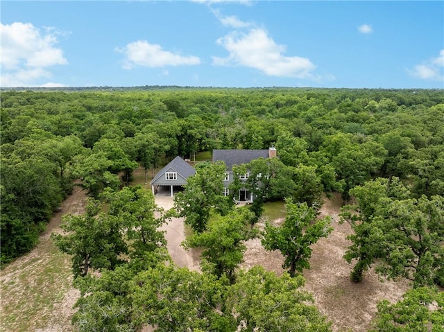 bird's eye view featuring a wooded view