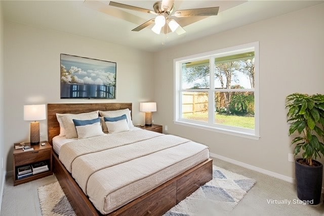 bedroom featuring ceiling fan and light colored carpet