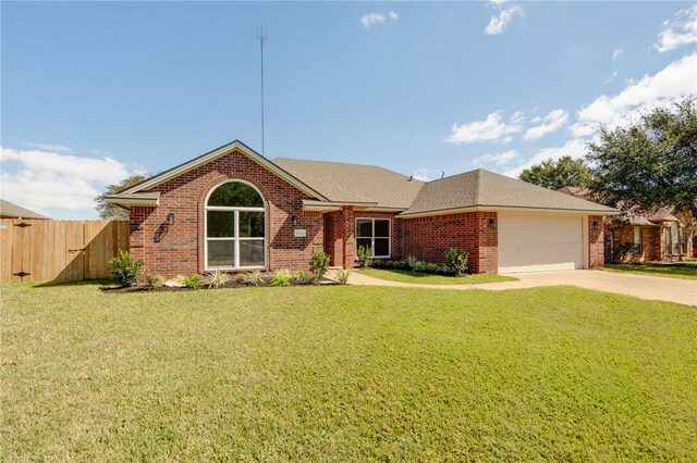 single story home featuring a front yard and a garage