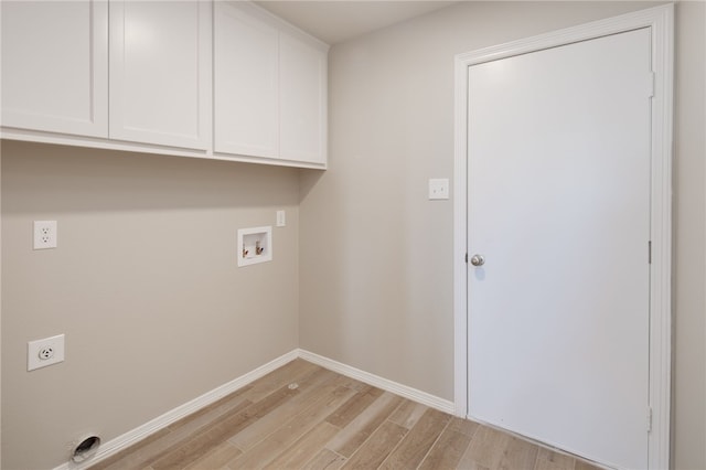 laundry area with hookup for a washing machine, electric dryer hookup, cabinet space, light wood-style flooring, and baseboards