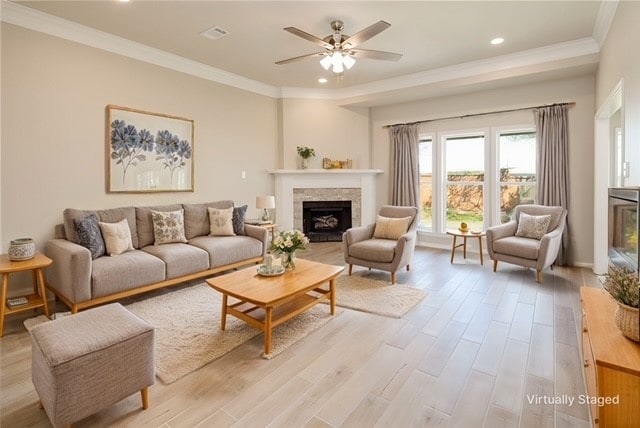 living room featuring light wood-type flooring, ceiling fan, and crown molding