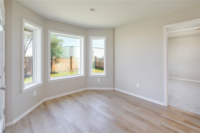 empty room with light hardwood / wood-style flooring