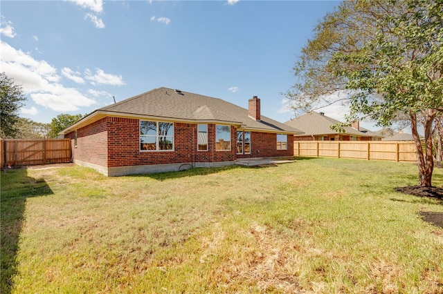 back of property featuring a lawn and a patio area