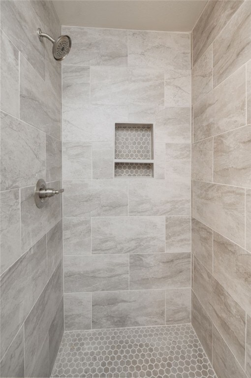 bathroom with a tile shower