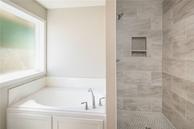 bathroom featuring plus walk in shower