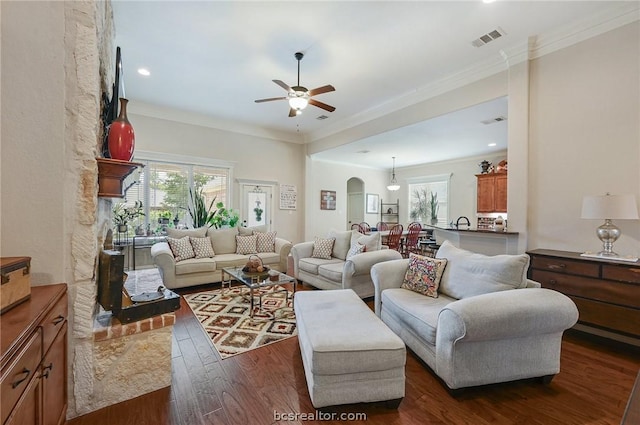 living room featuring dark hardwood / wood-style floors, ceiling fan, ornamental molding, and sink