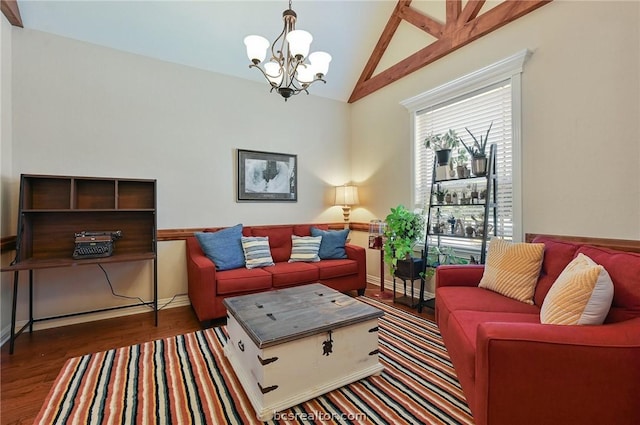 living room featuring a chandelier, dark hardwood / wood-style floors, and vaulted ceiling