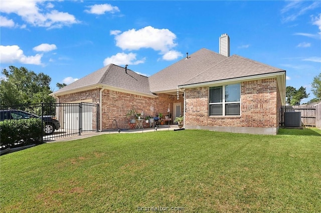 view of front of house with a patio area, central air condition unit, and a front lawn