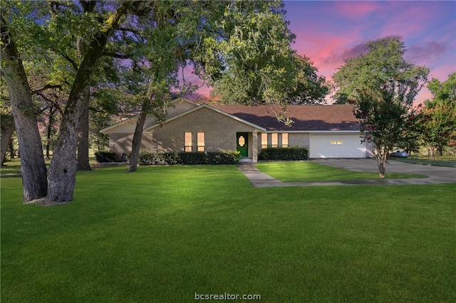 single story home with a yard and a garage