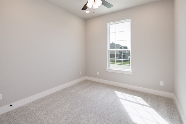 spare room with carpet, ceiling fan, and a wealth of natural light